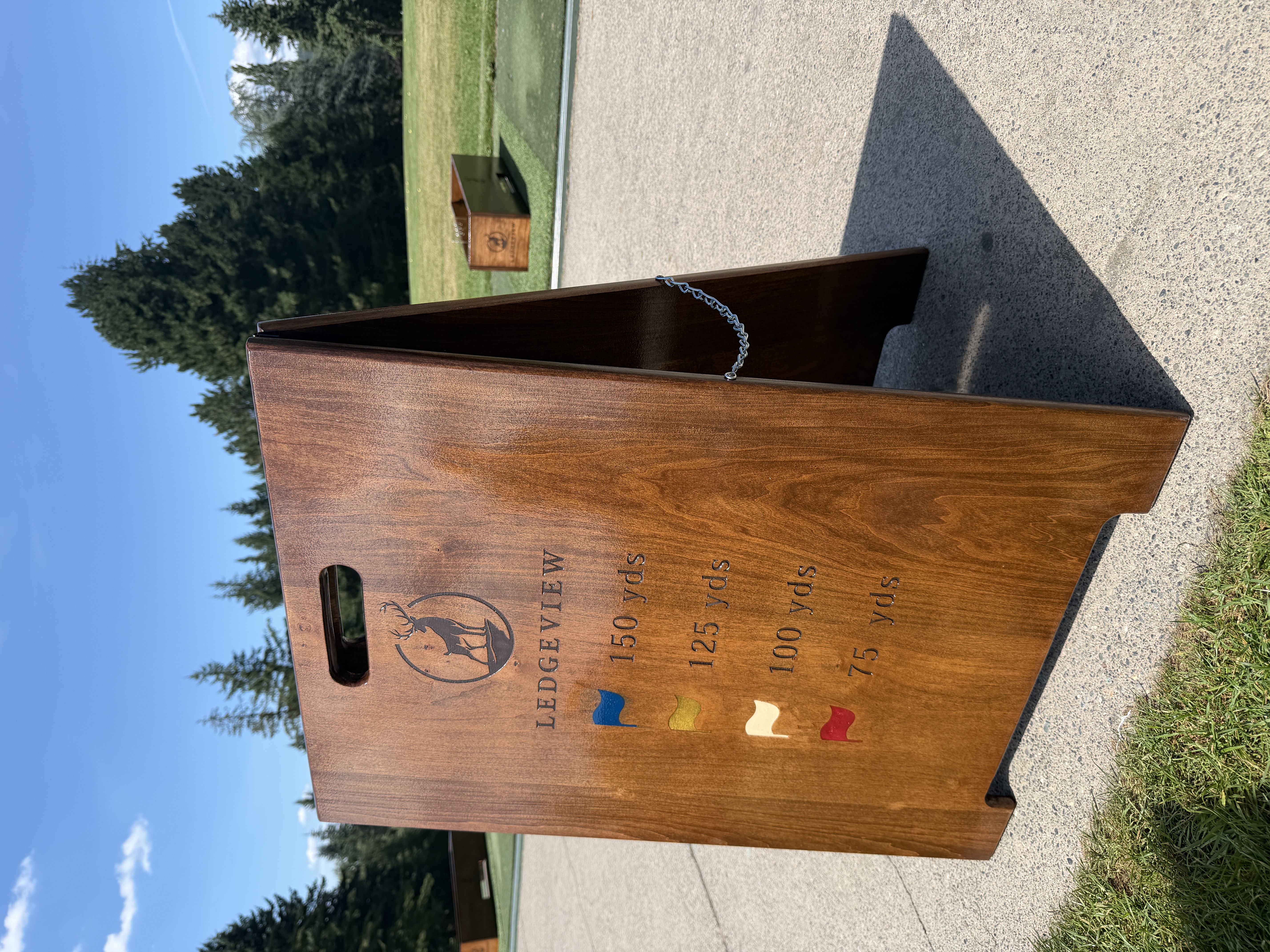 Freestanding walnut range yardage marker with Ledgeview Golf Club logo and colour-coded distance markings for 75, 100, 125, and 150 yards.