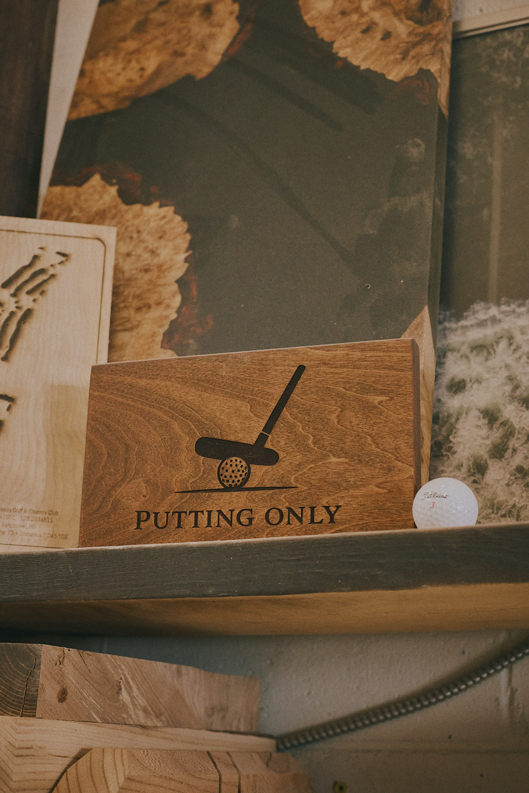 Finished Putting Only sign on the studio shelf alongside other completed pieces.